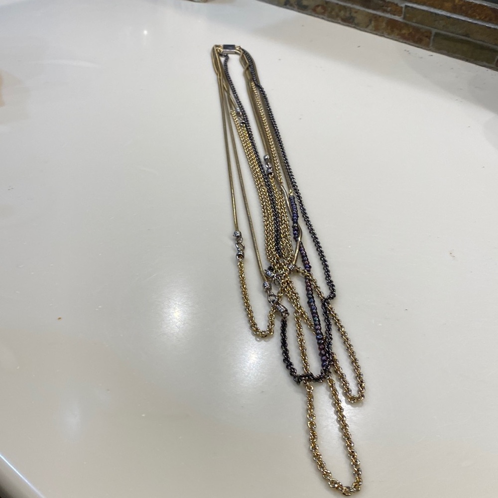 Gold & platinum multi chain necklace.little line of water pearls. Not real gold.